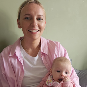 Smiling mother holding a young baby